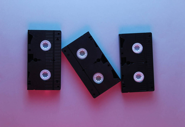 Retro style, 80s. Video cassette. Neon light, top view - Foto, Imagem