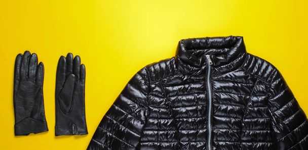 Fashionable women's clothing and accessories. Jacket, gloves on yellow background. Top view - Photo, Image