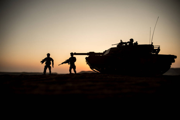 Háborús koncepció. Páncélozott jármű sziluettje harcok jelenet a háború köd ég háttérben. Amerikai tank naplementekor. - Fotó, kép