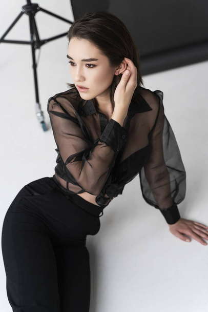 Beautiful Asian girl wearing trousers, a transparent blouse and  - Zdjęcie, obraz