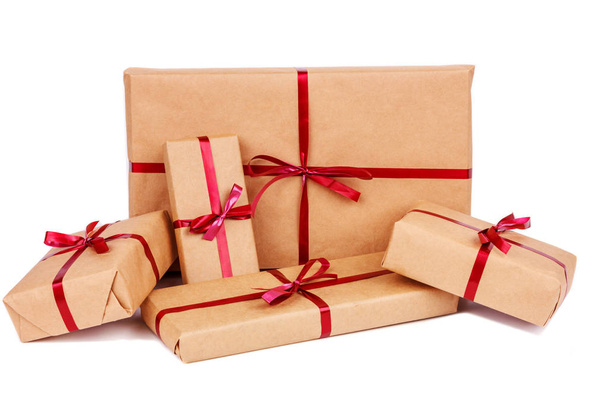 Gift Boxes in Craft Wrapping Paper with Red Ribbons isolated - Valokuva, kuva