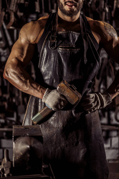 cropped blacksmith holding hammer - Fotó, kép