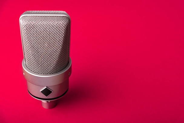Large diaphragm condenser studio microphone. On a red background. - Photo, Image