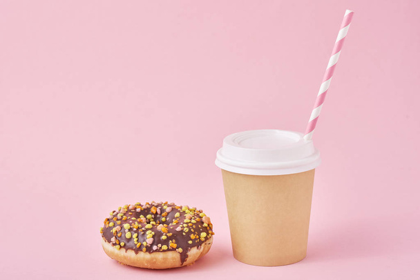 Cup of coffee and donut on a pink background - Fotoğraf, Görsel
