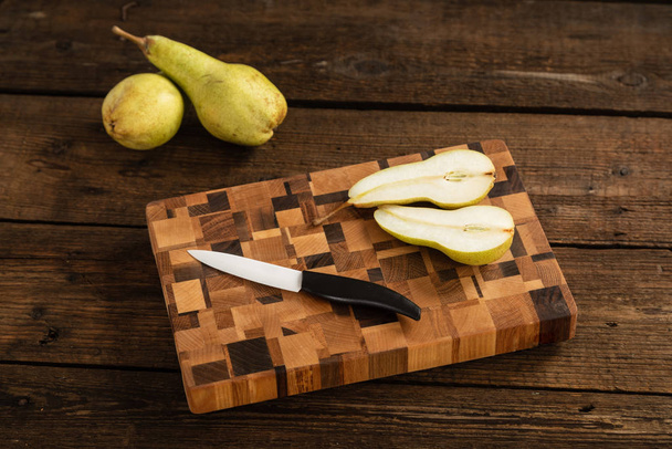 Sliced pile on a wooden cutting board. - Φωτογραφία, εικόνα