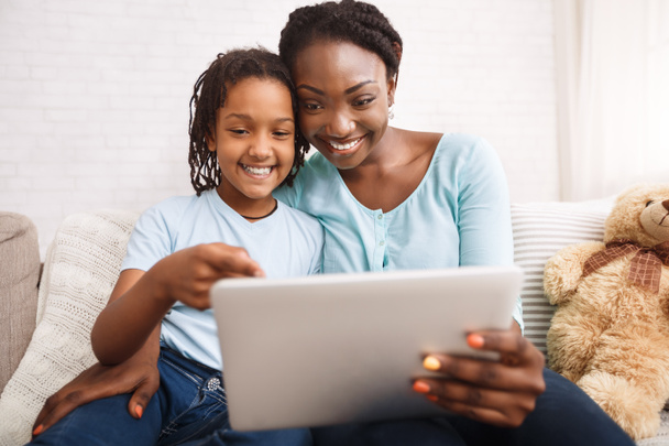 Afro mom and daughter making video call - Foto, imagen