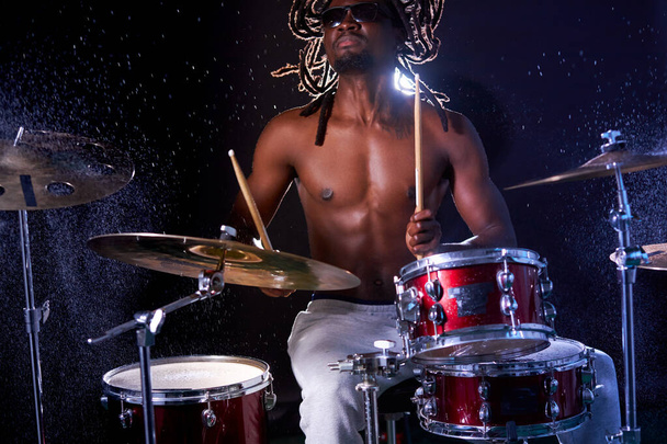 african drummer rehearsing on drums before his rock concert - Fotó, kép