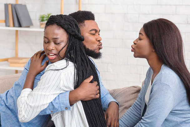Unfaithful Black Boyfriend Kissing Another Girl While Hugging His Girlfriend - Photo, Image