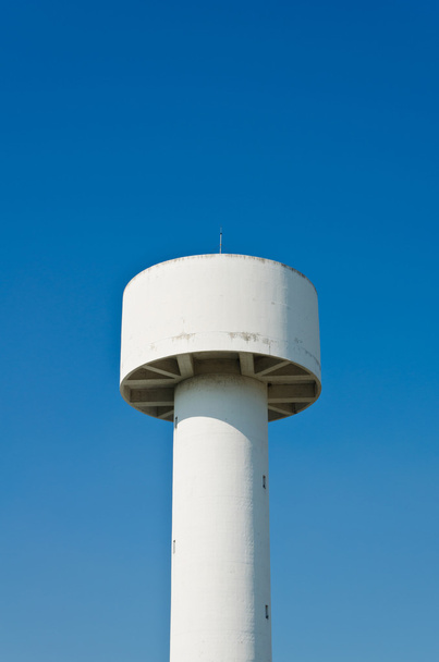 White water tower in the blue sky - Фото, изображение