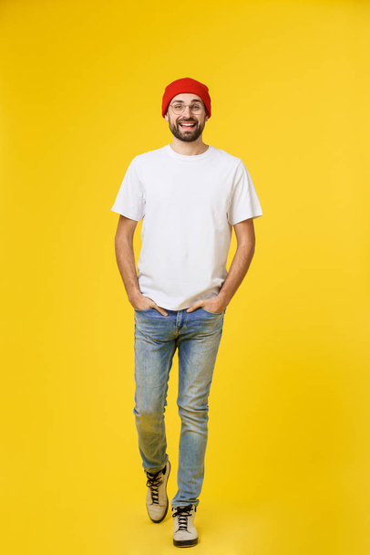 young hipster man wearing hat , suspenders, isolate on yellow background. - Foto, Imagem