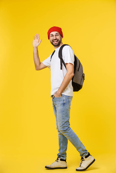 young hipster man wearing hat , suspenders, isolate on yellow background. - Φωτογραφία, εικόνα