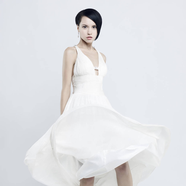 Fashionable photo of beautiful young woman in billowing white dress - Zdjęcie, obraz