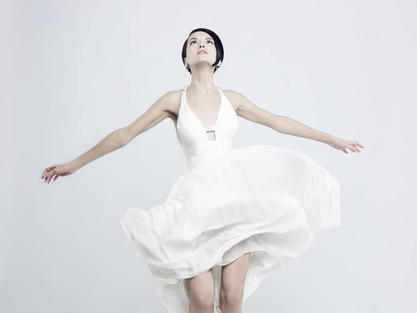 Fashionable photo of beautiful young woman in billowing white dress - Fotografie, Obrázek