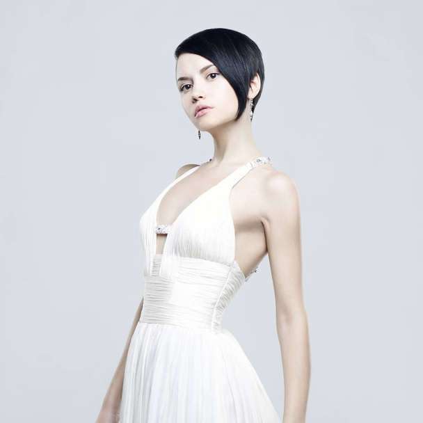 Fashionable photo of beautiful young woman in billowing white dress - Fotografie, Obrázek