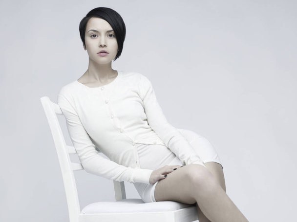 Elegant beautiful woman sitting on white background - Valokuva, kuva