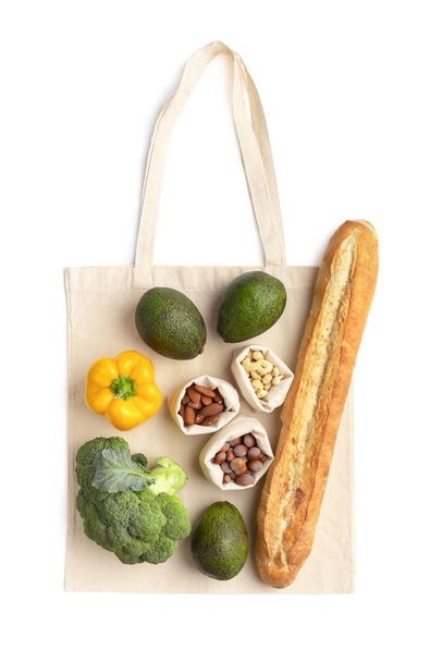 Vegetarian products decorating eco cotton bag on white - Photo, Image