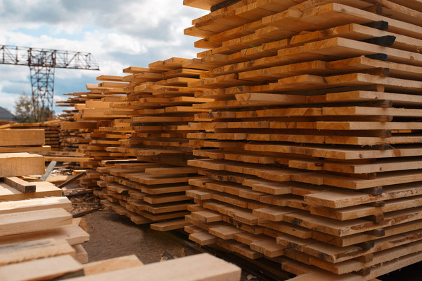 Stacks of boards on timber mill warehouse outdoor, nobody, lumber industry, carpentry. Wood processing on factory, forest sawing in lumberyard, sawmill - Photo, Image