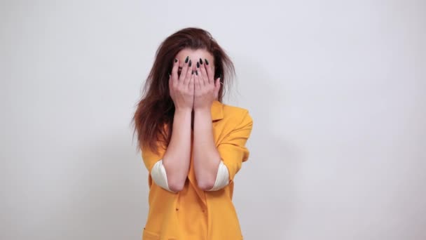 Attractive woman covering eyes, looking through hands - Footage, Video