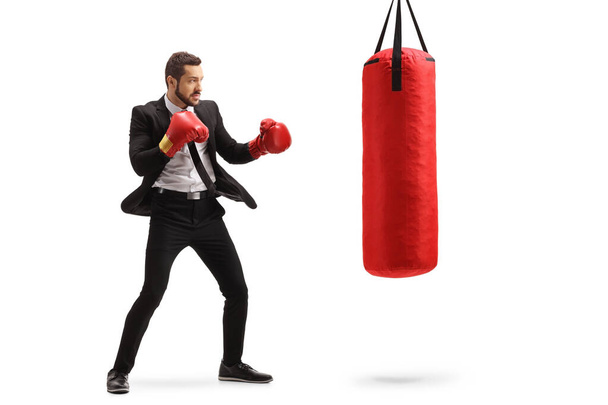 Businessman training box with a red punching bag - Foto, Bild