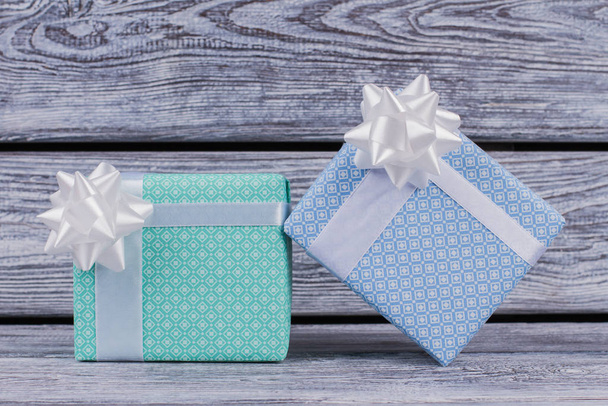 Beautifully packed present boxes on wooden background. - Photo, Image