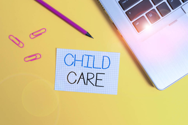 Word writing text Child Care. Business concept for a care of children especially as a service while parents at work Trendy metallic laptop clips pencil squared paper sheet colored background. - Photo, Image