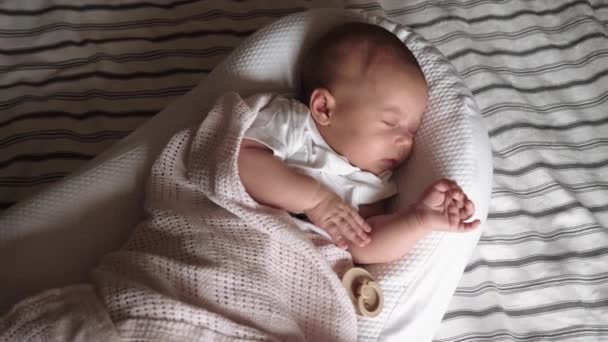 The baby sleeps in the cradle on the bed - Footage, Video
