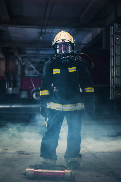 Portrait of a female firefighter wearing a helmet and all safety - Photo, Image