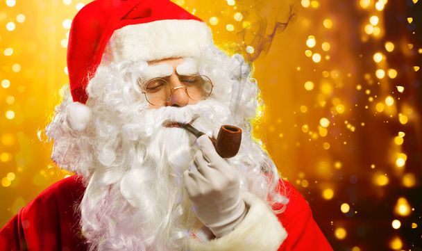 Santa Claus portrait smoking his pipe - Fotoğraf, Görsel