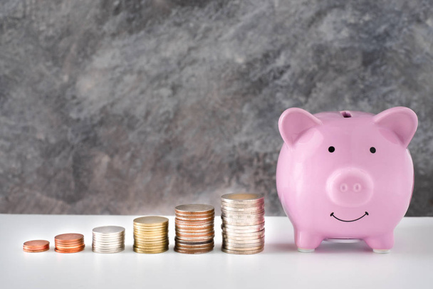 Close-up of pink piggy bank smile with coins stack stair step up growing growth saving money. concept Business Finance, Save money for future. with copy space. - Photo, Image