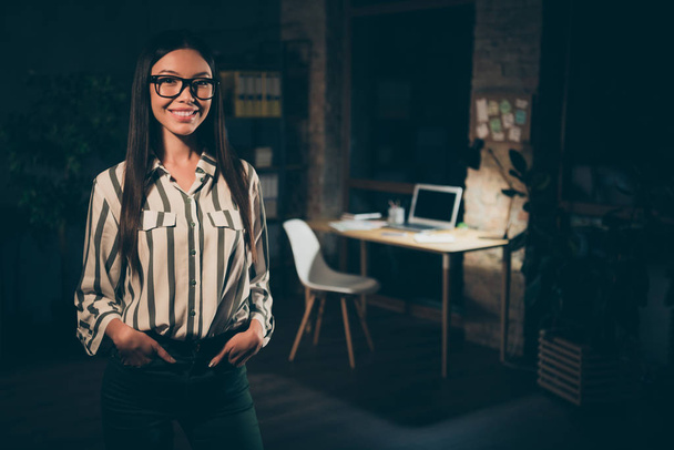 Photo of pretty asian business lady working late meeting foreign colleagues partners responsible reliable person friendly smiling wear specs striped shirt dark modern office - Фото, зображення