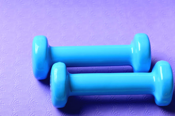 Barbells made of plastic, close up. Dumbbells in cyan color - Foto, Imagen