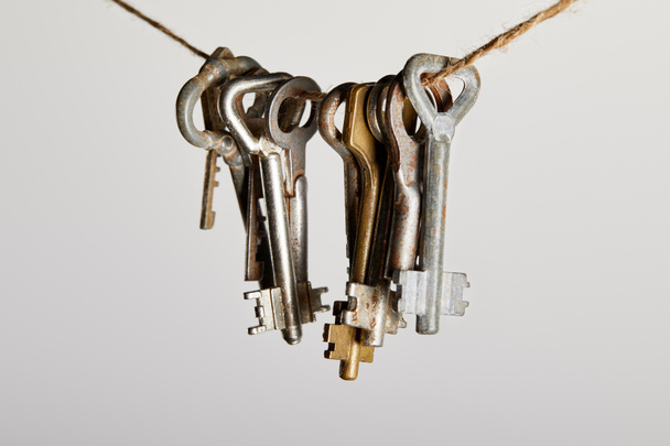 vintage rusty keys hanging on rope isolated on white - Photo, Image