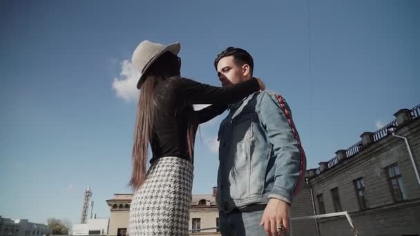 Stylish guy and girl posing in front of the camera on the street. - Materiał filmowy, wideo