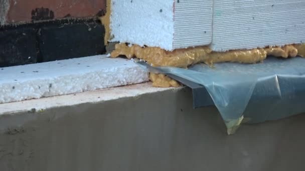 Old  house wall insulation with polystyrene and waterproofing foundation, zoom out - 映像、動画