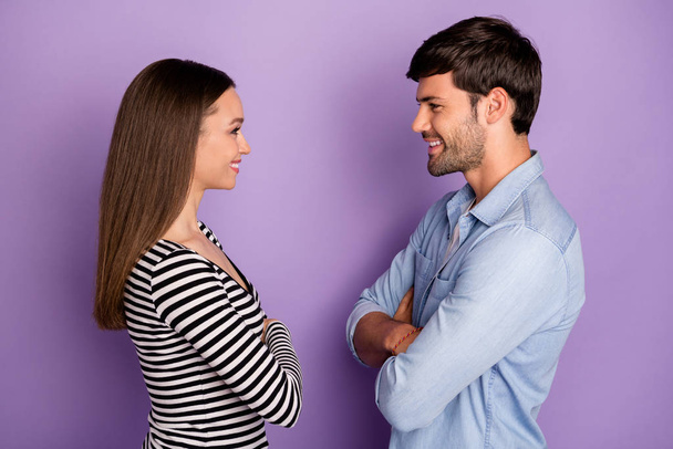 Profile photo of two people couple guy lady standing opposite looking eyes arms crossed friendly smiling wear stylish casual outfit isolated pastel purple color background - Фото, зображення