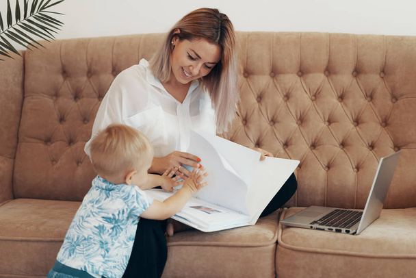 Όμορφη επιχειρηματίας που δουλεύει στο σπίτι. Multi-tasking, freelance και έννοια της μητρότητας - Φωτογραφία, εικόνα