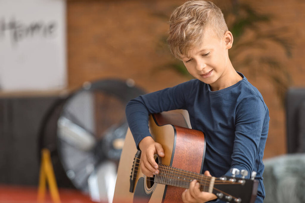 Little boy playing guitar at home - Fotografie, Obrázek