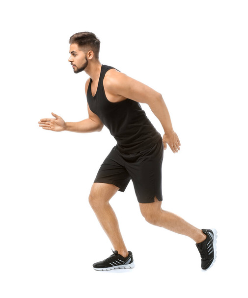 Σπορ νεαρός άνδρας τρέχει εναντίον λευκό φόντο - Φωτογραφία, εικόνα