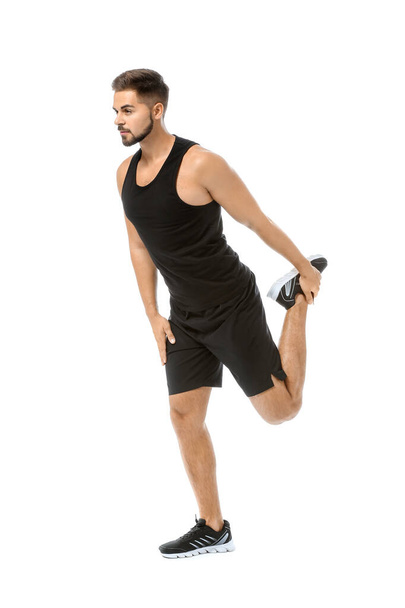 Sporty young man training against white background - Фото, изображение