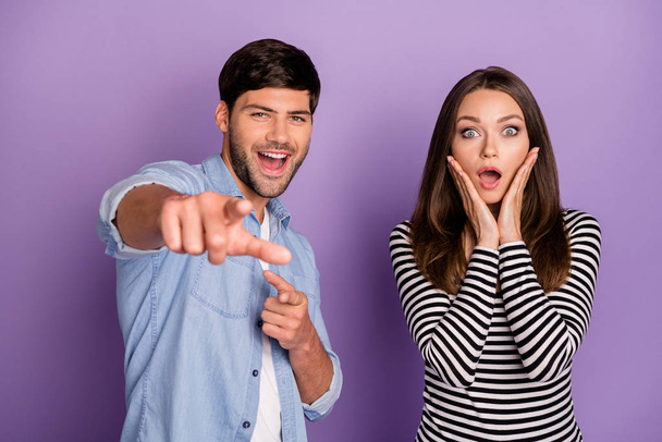 Its you. Photo of two funny people couple open mouth listen good news directing finger ahead wear stylish casual outfit clothes isolated pastel purple color background - Φωτογραφία, εικόνα