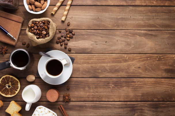 cup of coffee and beans on wooden background - Фото, изображение