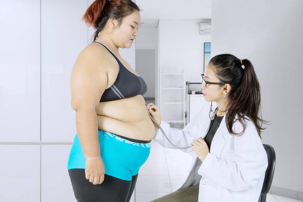 Fat woman visiting her doctor to have examination - Zdjęcie, obraz