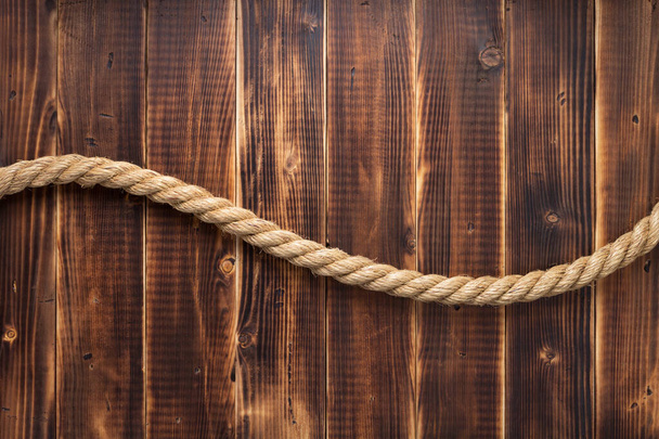 ship rope at wooden background - Foto, afbeelding