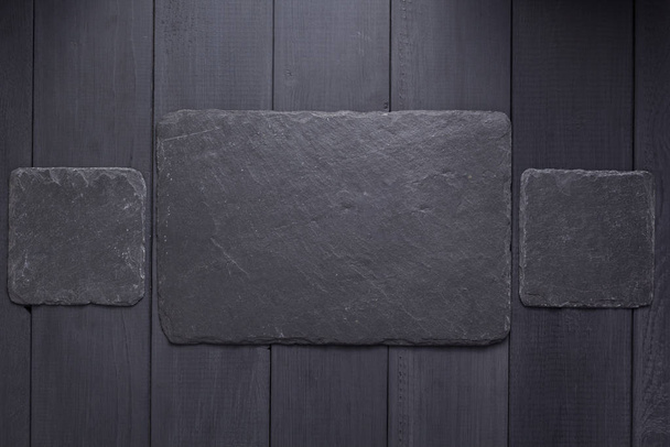 slate stone nameplate or wall sign at wooden background  - Foto, Bild