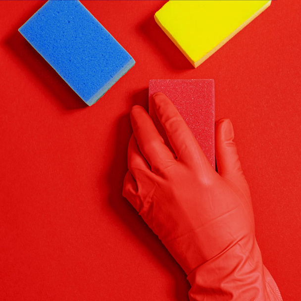 Employee hand in rubber protective glove with micro fiber cloth wiping wall from dust. Commercial cleaning company concept - 写真・画像
