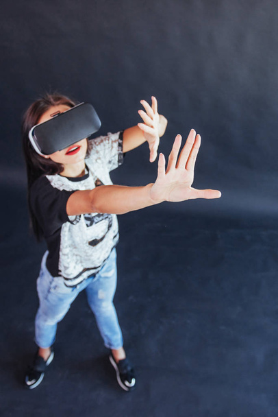 Happy woman gets experience of using VR-glasses virtual reality headset - Φωτογραφία, εικόνα