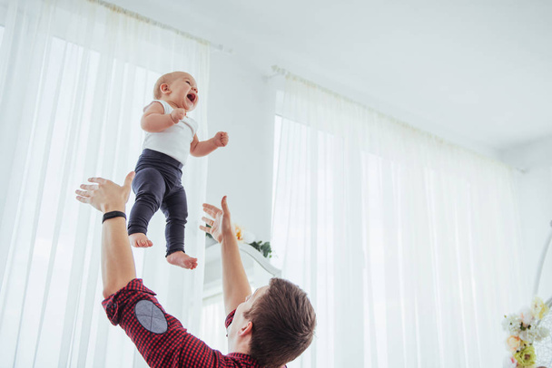 Father throwing hand high air joyful daughter. The concept of a friendly family. - Fotoğraf, Görsel