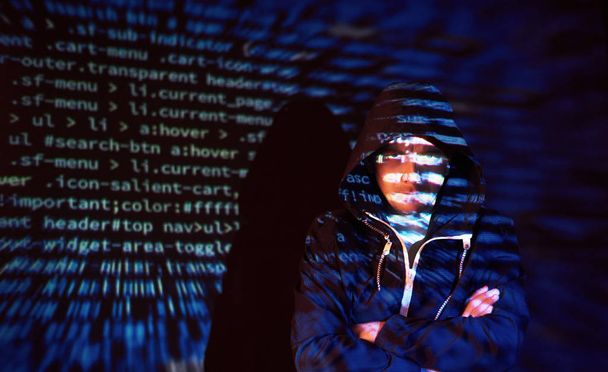 Cyber attack with unrecognizable hooded hacker using virtual reality, digital glitch effect. - Фото, зображення