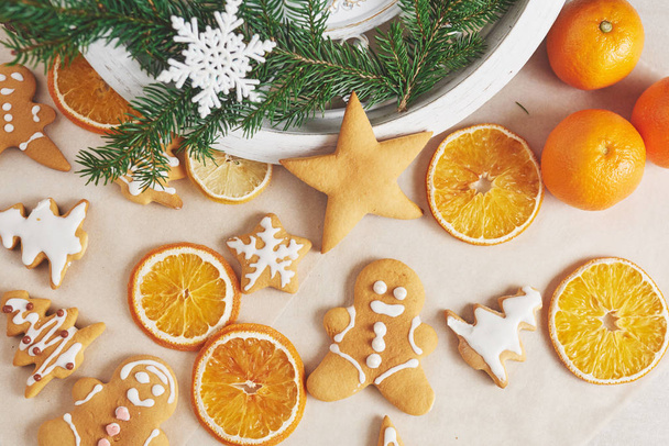 Decorating gingerbread cookies with white icing, selective focus and place for text. - Foto, afbeelding
