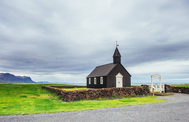 Mountain View Iceland. Beautiful black wooden church in Budir. - 写真・画像